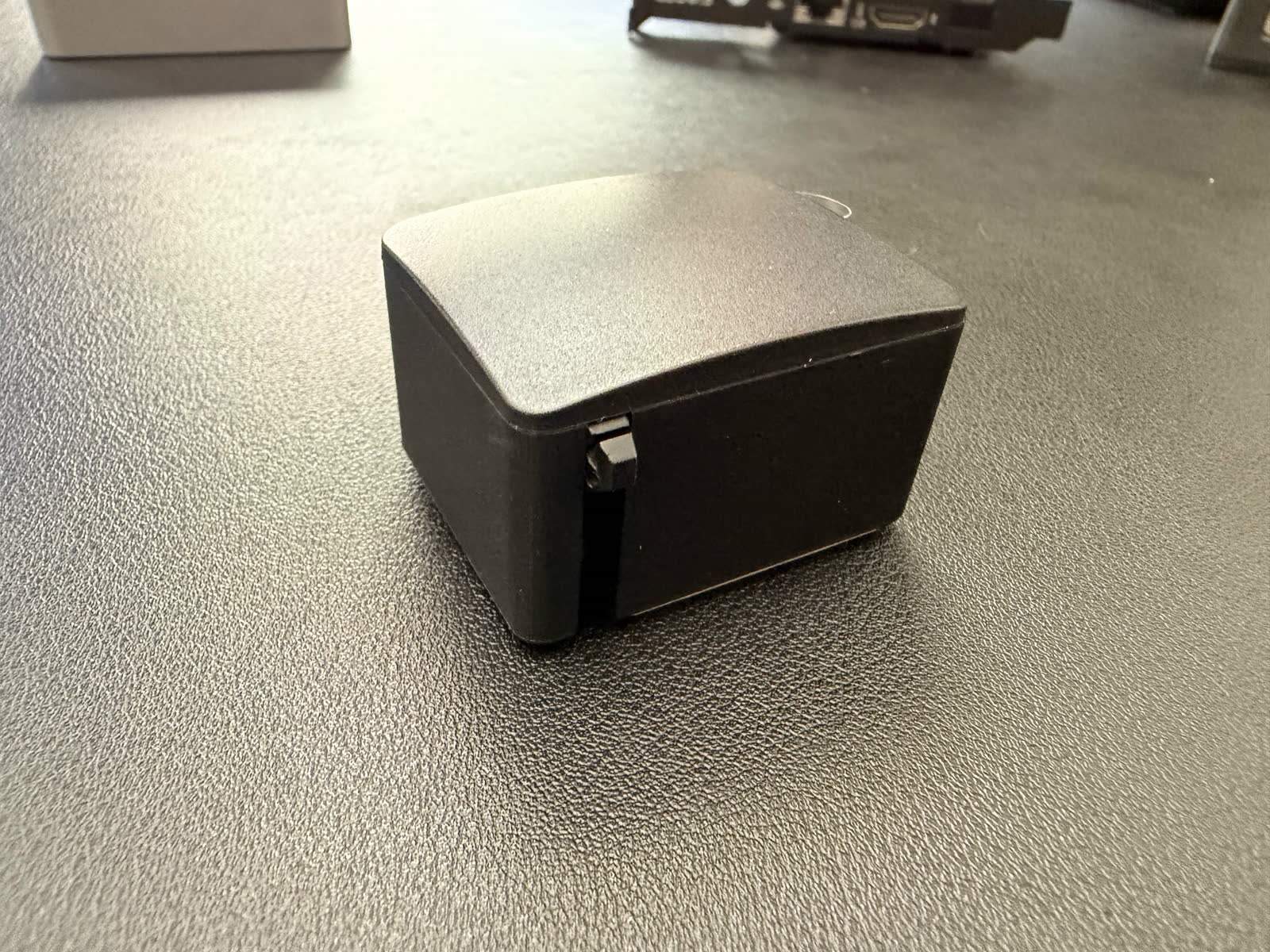 Photo of the wireless Fingerbot mounted over a PC power button, the accessory owners love for remote power without an ATX header.