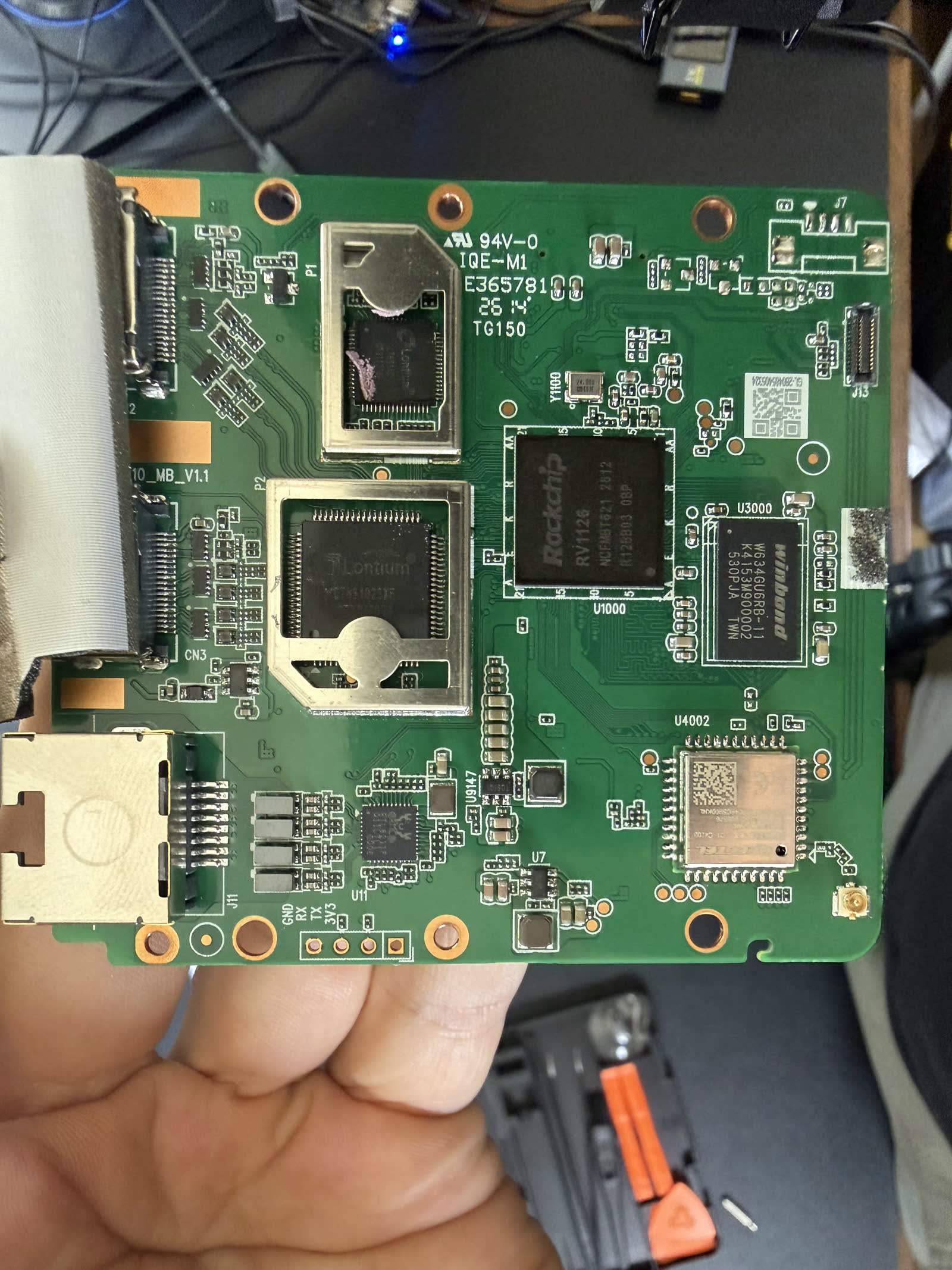 The GL.iNet Comet Pro opened up, its mainboard and capture silicon exposed.