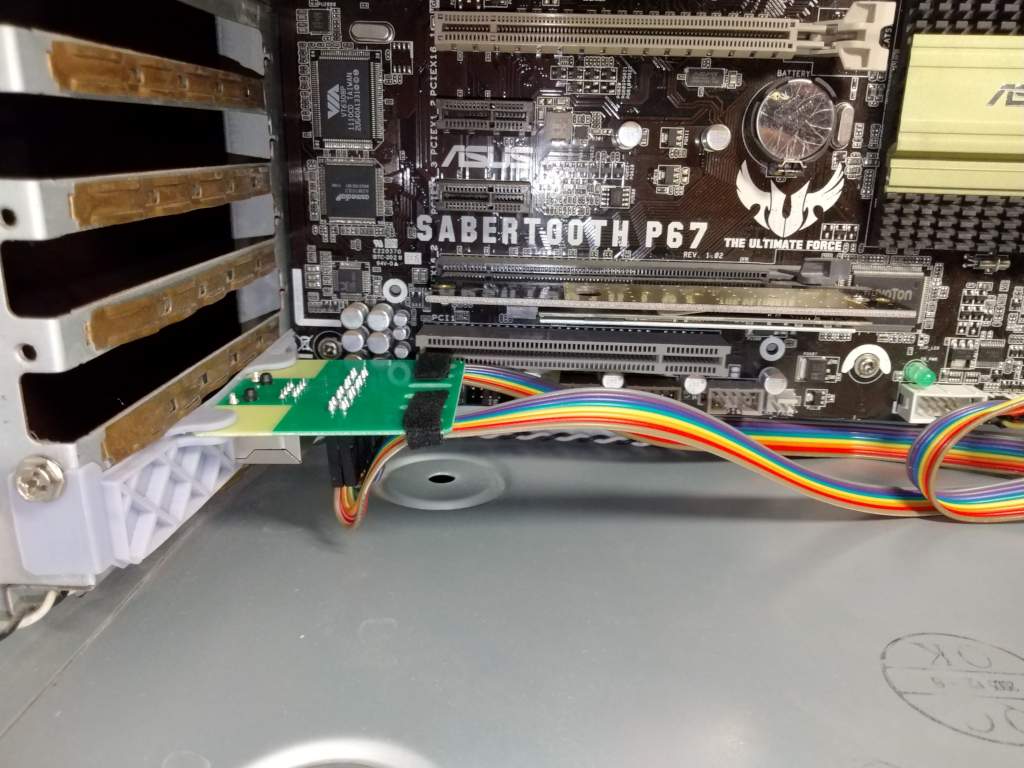 Photo of the PiKVM ATX board wired into a motherboard, with the web UI power controls alongside, showing remote power and reset.