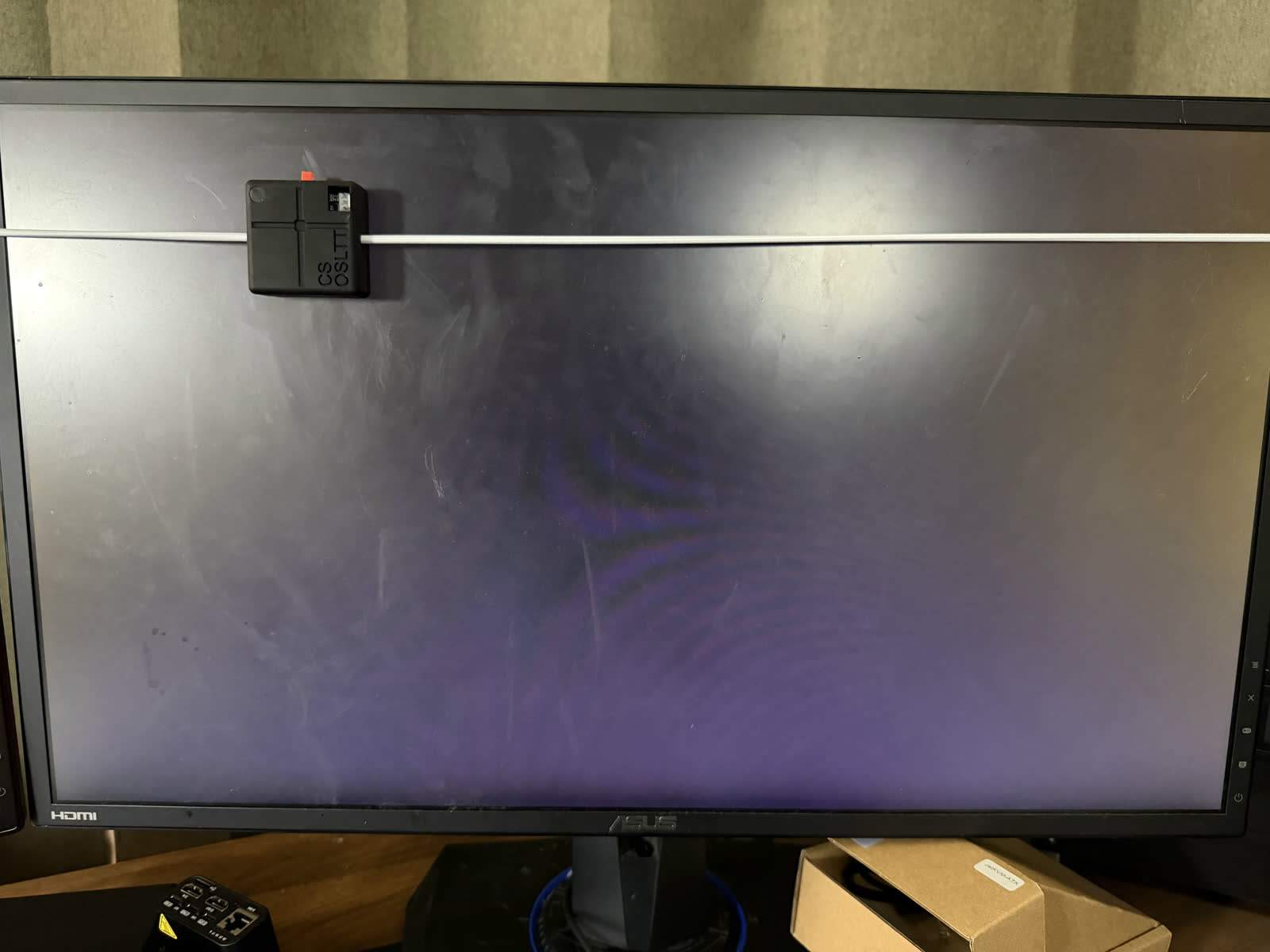 Our light sensor on the monitor, measuring click-to-photon latency at the glass.