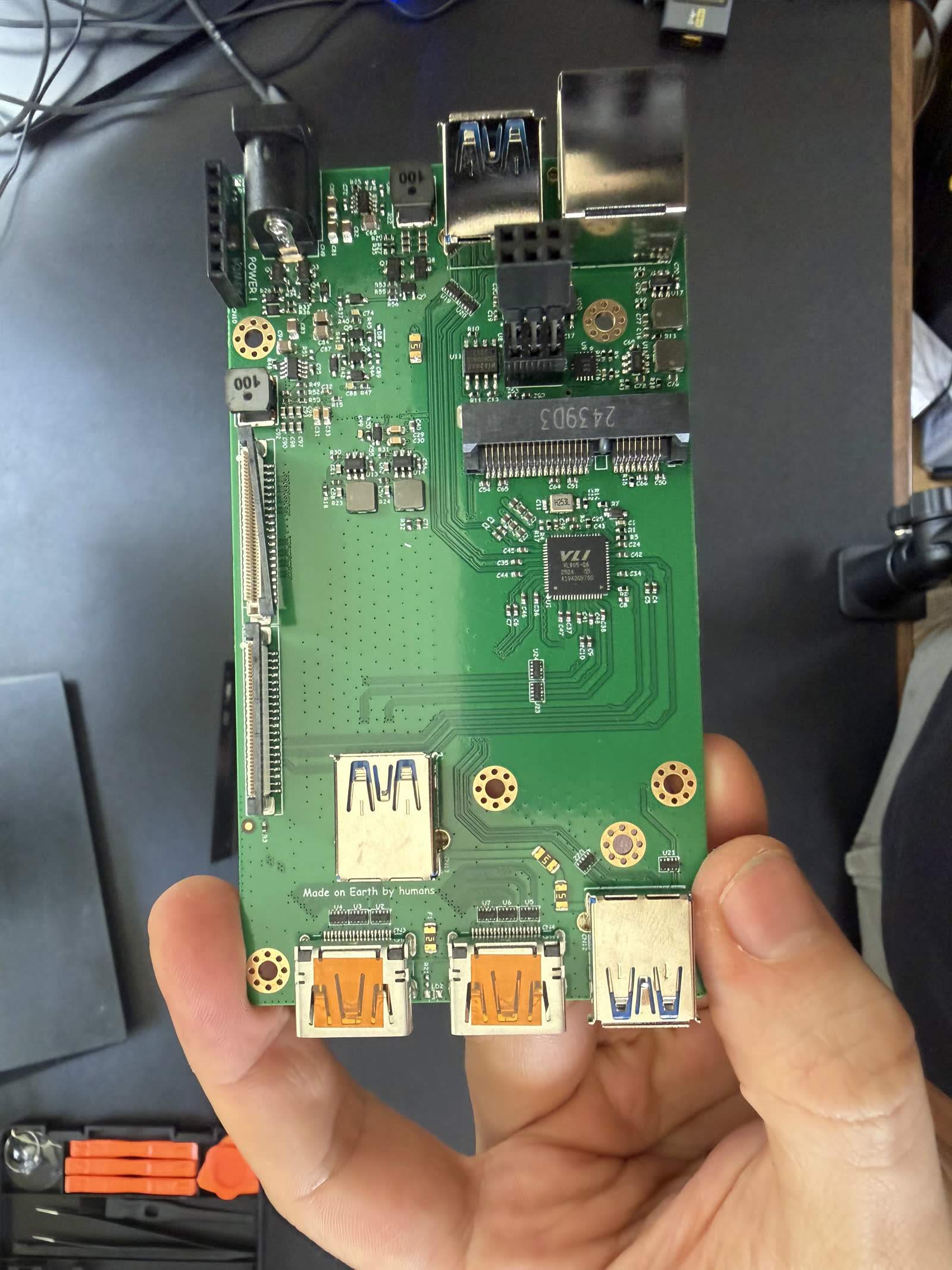The opened PiKVM V4 Plus with the CM4 seated on the carrier board that carries the capture path and ports.