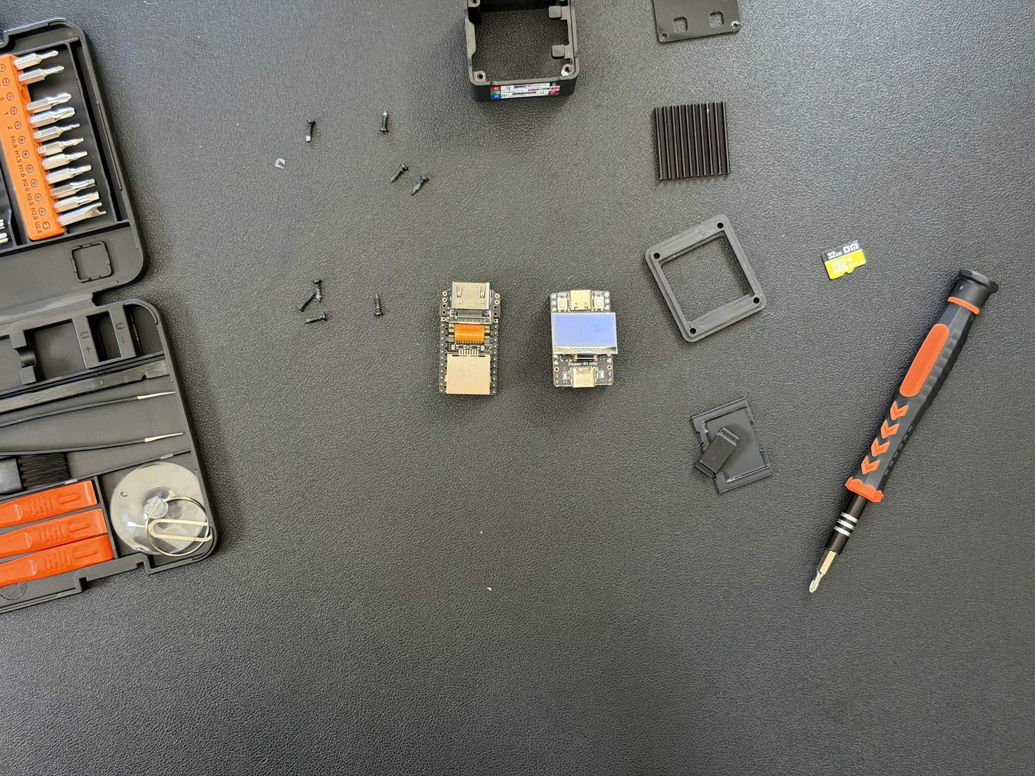 The NanoKVM Full's boards laid out flat after disassembly, connectors visible.