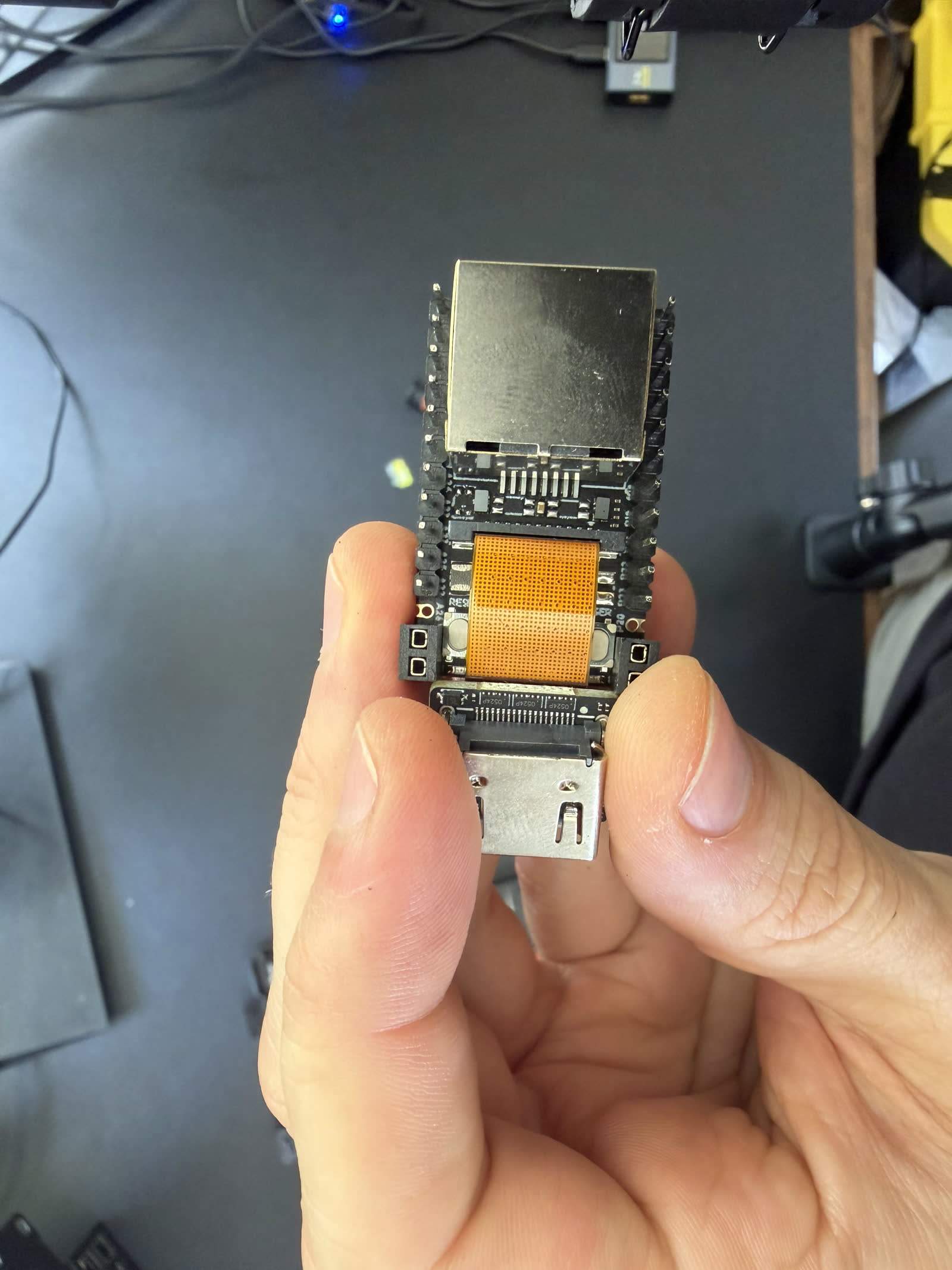 Macro of the area on our NanoKVM Full/PCIe board where the reported microphone would sit, showing no physical mic capsule present, with a coin for scale.
