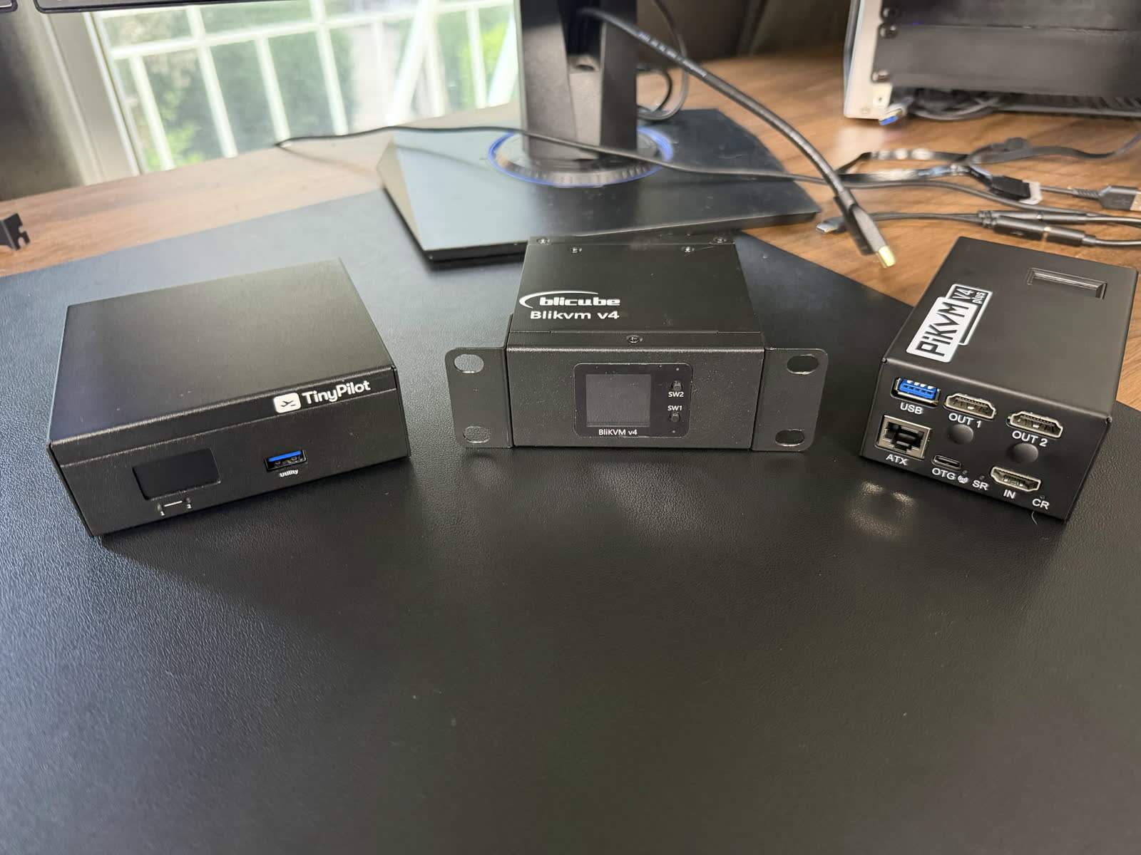 The TinyPilot Voyager 3 beside the PiKVM on the bench.
