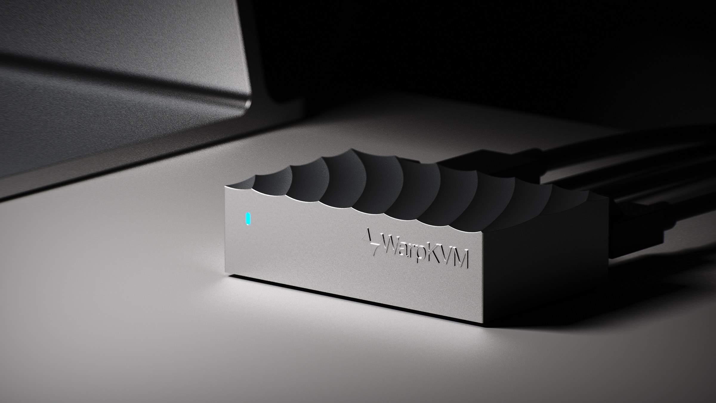 WarpKVM 01 with its wave-shaped aluminum top, dramatically lit on a desk