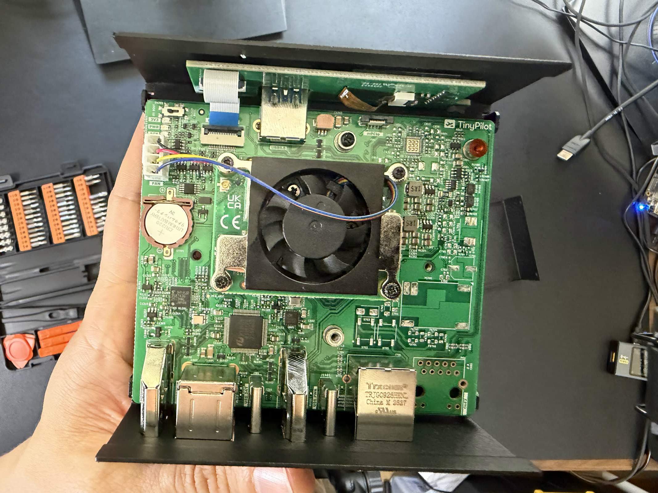 The opened Voyager 3 with the mainboard exposed and the CM4 under its fan in the socket.
