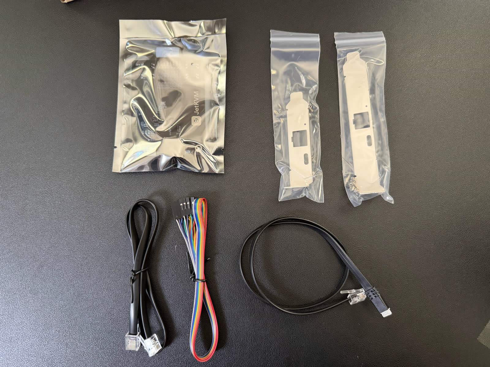 The JetKVM extension accessories laid out, showing the connector type.