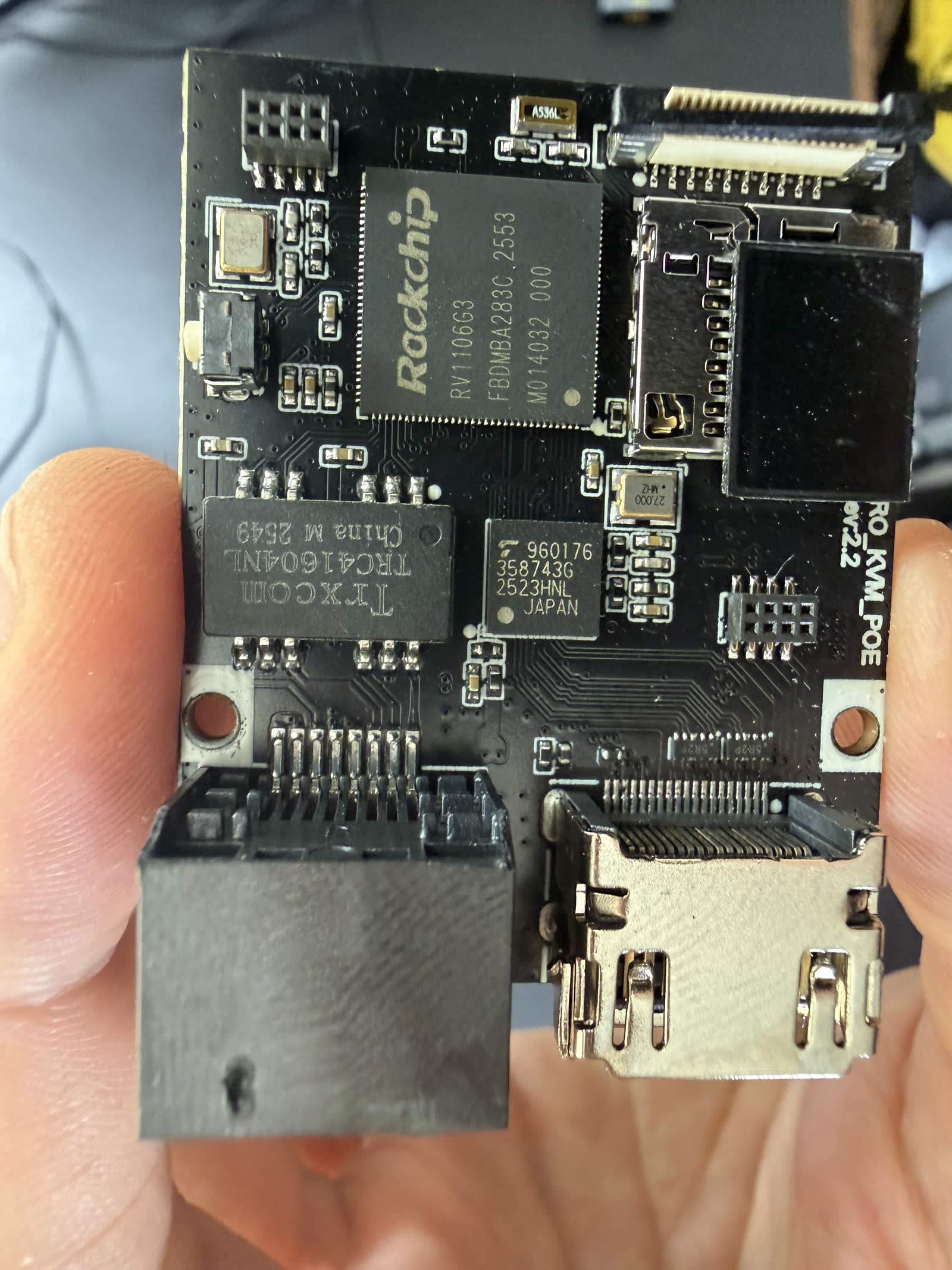 JetKVM board interior showing the Rockchip RV1106 SoC and Toshiba TC358743 capture chip