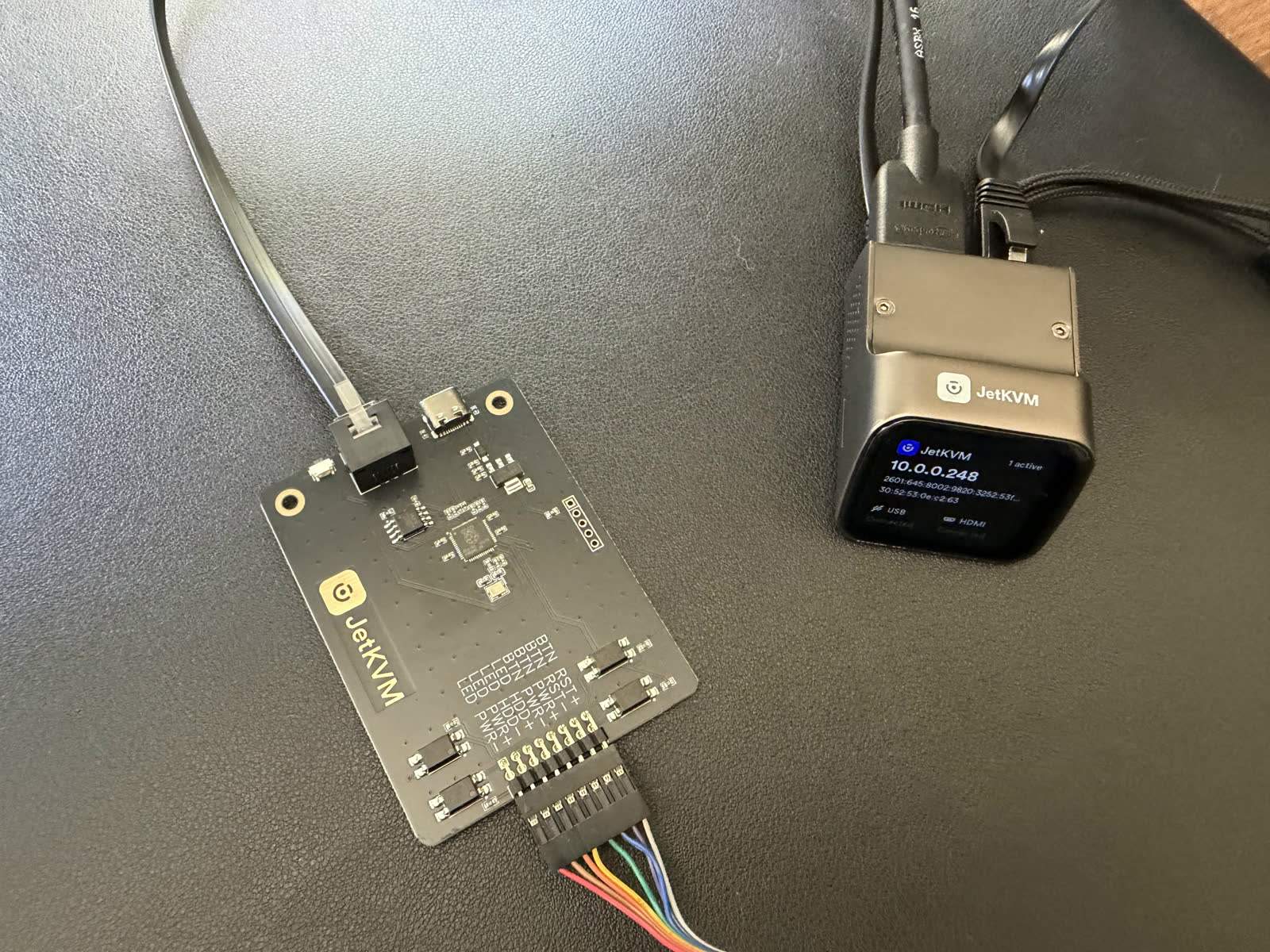 The JetKVM powered up and wired to its ATX extension board.