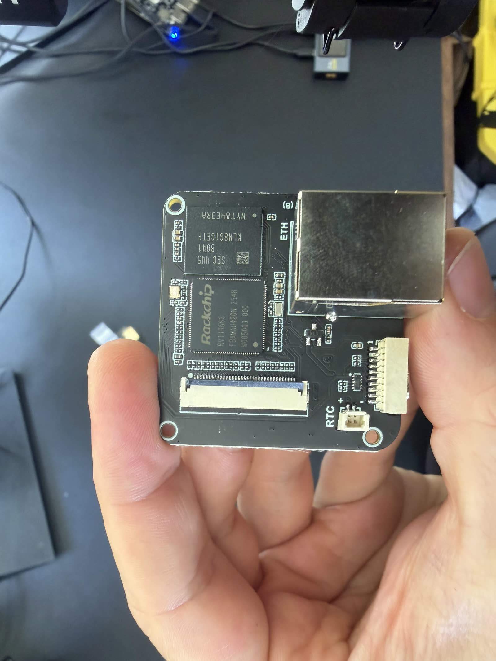 The PicoKVM's SoC board: the Rockchip RV1106G3 beside the soldered Samsung KLM8G1GETF eMMC, with the Ethernet jack and RTC connector.